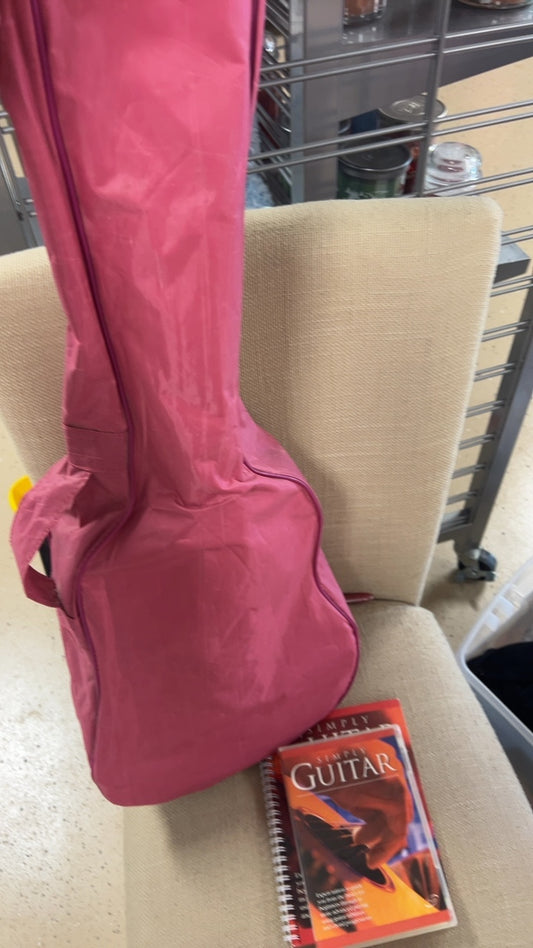 Guitar, pink case, and books